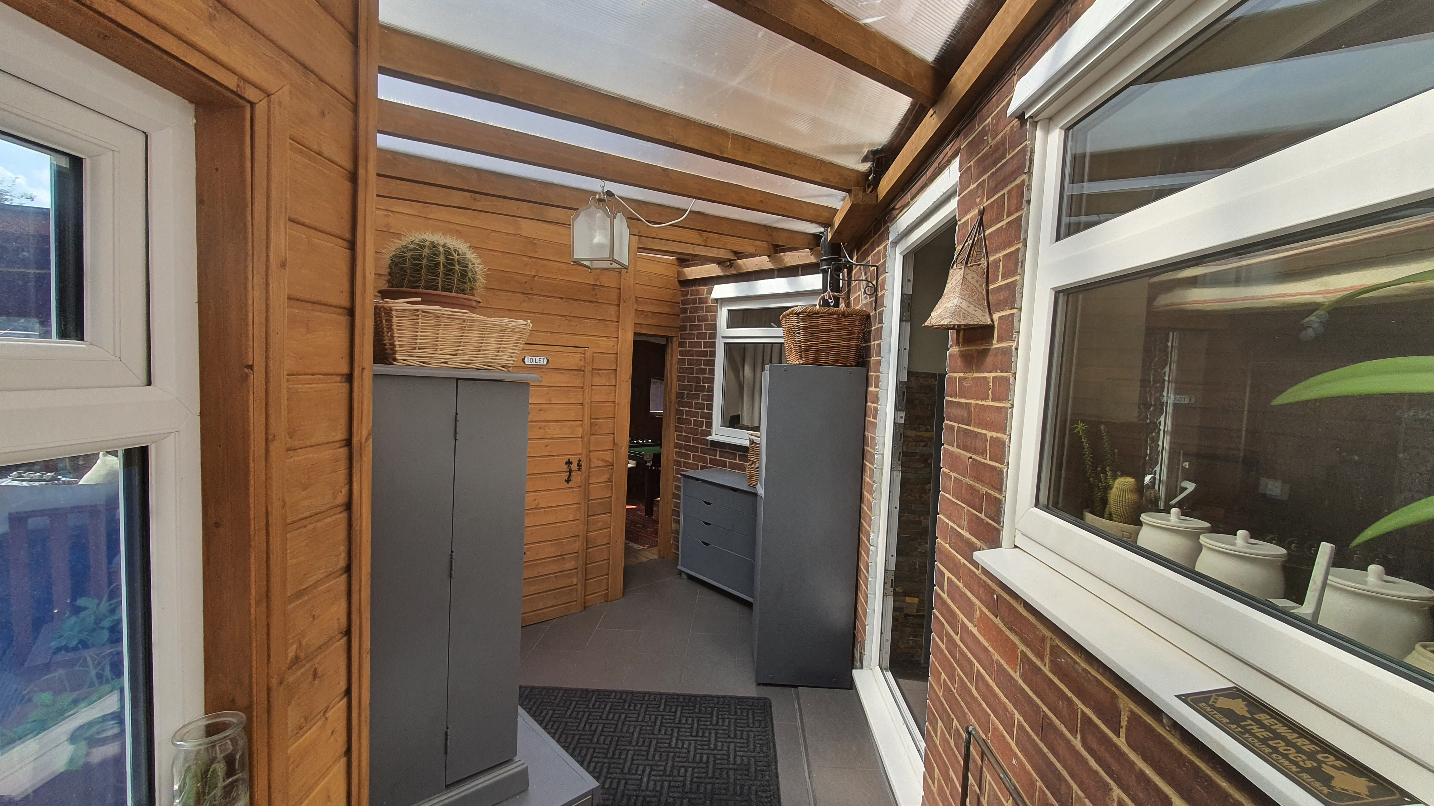 The view inside of an extension with a plastic roof created for a storage section.